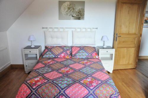 a bedroom with a large bed with two night stands at Gîte de France De chapdevialle la croisée des vents 4 épis - Gîte de France 12 personnes MAE-0064 in Juillac