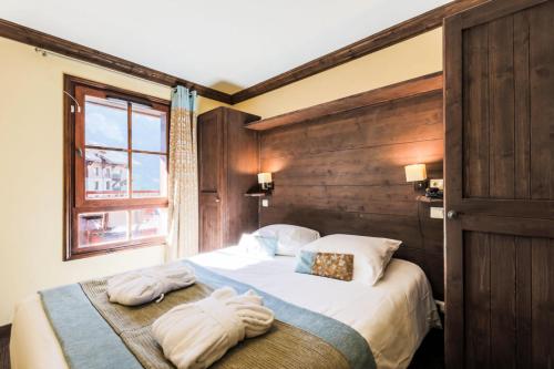 une chambre avec un lit avec des serviettes dessus dans l'établissement Résidence Les Arcs 1950 Le Village - maeva Home - Appartement 2 pièces 4 personnes - Sélection MAE-3894, à Bourg-Saint-Maurice