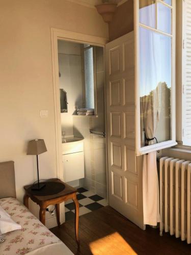 a bedroom with a bed and a window and a door at Gîte de France A perle de vue 4 épis - Gîte de France 14 personnes MAE-0294 in Uzerche