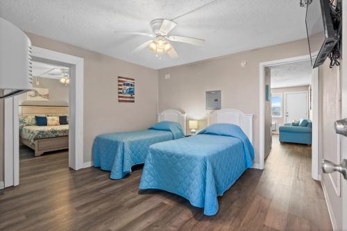 a bedroom with two beds and a ceiling fan at Blue Mist Villas Unit 102 - Oceanfront Ground Floor Condo in Cherry Grove in Myrtle Beach