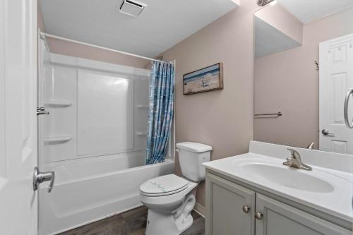 a bathroom with a toilet and a sink and a shower at Blue Mist Villas Unit 102 - Oceanfront Ground Floor Condo in Cherry Grove in Myrtle Beach