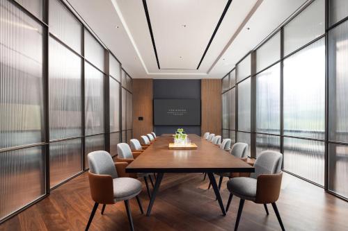 a conference room with a long table and chairs at New World Guangzhou Hotel-- FREE Canton Fair Shuttle Bus in Guangzhou