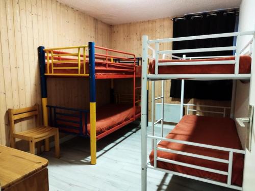 a room with two bunk beds and a table at Résidence Rond-Point-pistes I - 3 Pièces pour 8 Personnes 224 in Orcières