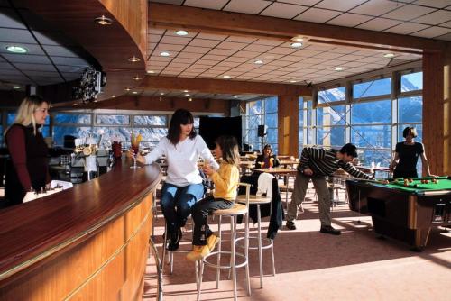 a group of people sitting at a bar at Résidence Rond-Point-pistes I - 2 Pièces pour 8 Personnes 234 in Orcières