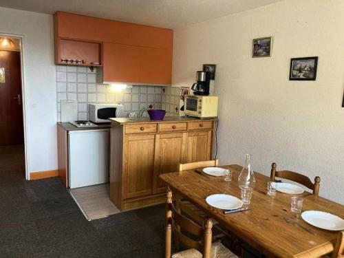- une cuisine avec une table en bois, des chaises et une table dans l'établissement Résidence Rond-point-pistes Ii - Maxi studio 4 pers. au centre station MAE-9574, à Orcières