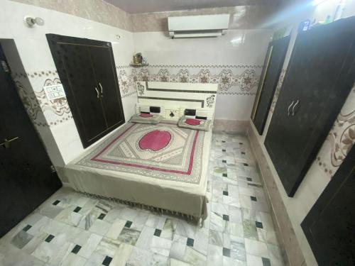 an overhead view of a bathroom with a rug on the floor at Anne Guest House in Jodhpur