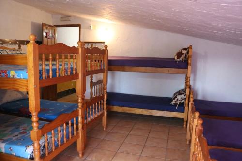 two bunk beds are in a room with a ceiling at Casa rural para grupos in Ayora