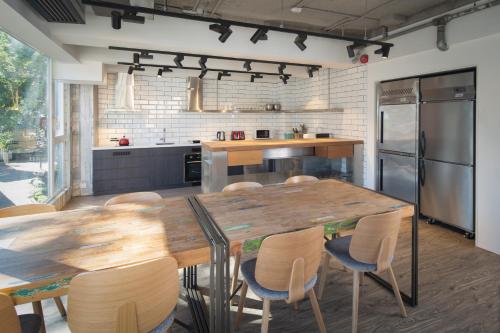 a kitchen with a large wooden table and chairs at The Aberdeen Harbour by Ovolo in Hong Kong