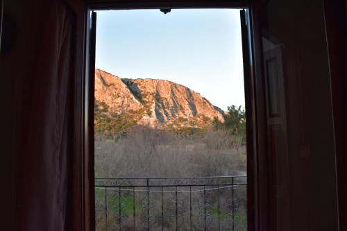 a window with a view of a mountain at Val's place in Mytilini
