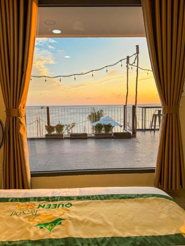 a bedroom with a view of the ocean from a balcony at Queen Sea Resort - Đảo Phú Quý in Cu Lao Thu