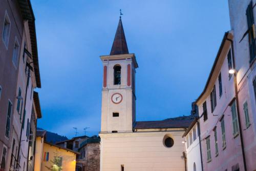 a clock tower on the side of a building at Le Case di Maggie in Isolabona