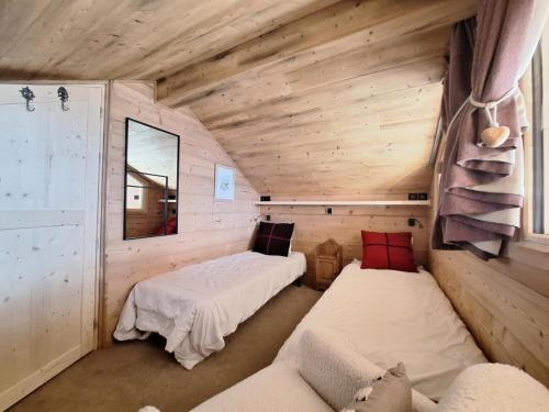 a room with two beds in a log cabin at Chalet De Bellecote - Chalets pour 8 Personnes 96 in Peisey-Nancroix