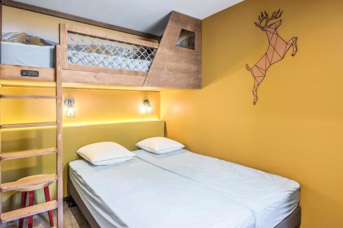 a bedroom with a bunk bed and a ladder at Résidence Arietis - Atria-Crozats - maeva Home - Appartement 2 Pièces 5 Per 29 in Morzine