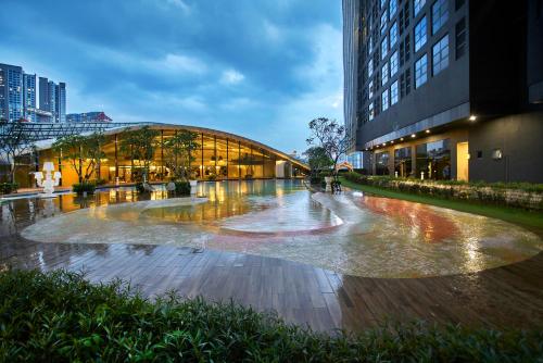 a building with a fountain in the middle of a street at Arte Mont Kiara Free Parking, Kuala Lumpur in Kuala Lumpur
