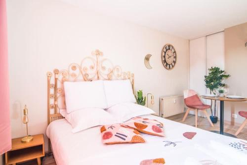 a bedroom with a large white bed with white pillows at Parking - Le Lotus - Tram in Strasbourg