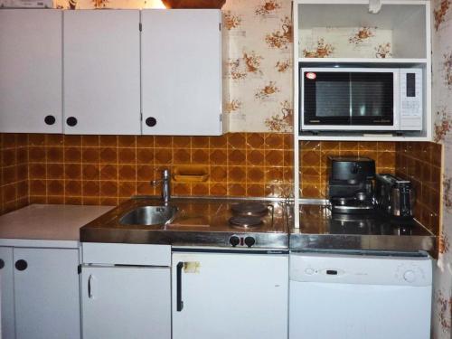 une cuisine avec un évier et un micro-ondes dans l'établissement Résidence Les Cembros - SUPERBE VUE SUR LES PISTES MAE-2254, à Le Mélézet