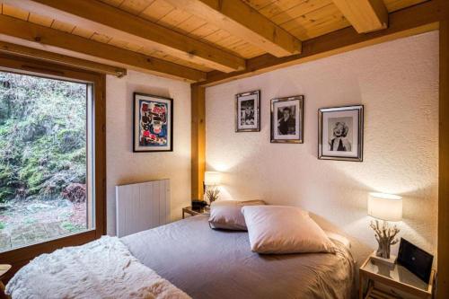 a bedroom with a large bed and a window at Cocoon In Megève in Megève