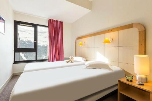 Ένα ή περισσότερα κρεβάτια σε δωμάτιο στο Résidence La Forêt - maeva Home - Appartement 2 Pièces 5 Personnes - Confort MAE-4236