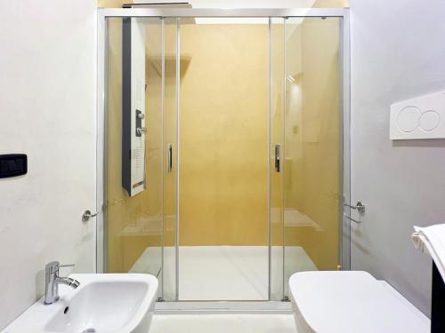 a shower with a glass door in a bathroom at Central with hydromassage shower and elevator in Perugia