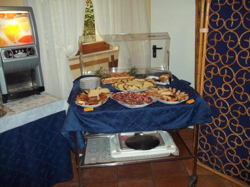 a table with a blue table cloth with food on it at Hotel Relais Valle Orientina in Pitigliano