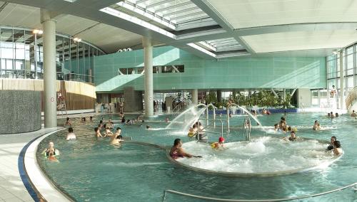 a group of people in a swimming pool in a mall at Matin d'été in Chartres