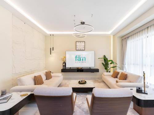 a living room with a couch and a tv at FAM Living - Stunning 2 Bedroom Home In JBR in Dubai