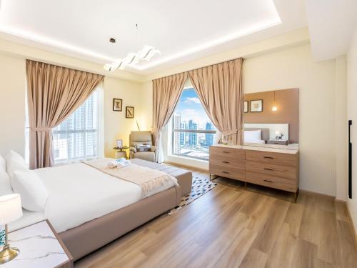 a bedroom with a large bed and a large window at FAM Living - Stunning 2 Bedroom Home In JBR in Dubai