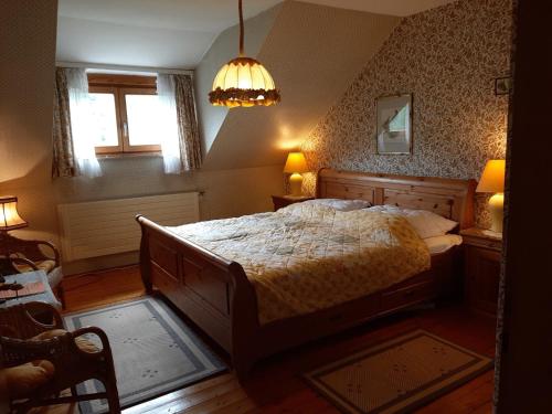a bedroom with a large bed and a window at Ferienwohnung Sankt Hubertus in Bad Berneck im Fichtelgebirge