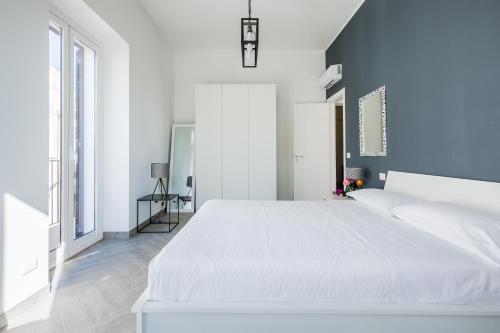ドンナルカータにあるDonnalucata Ospitalità Diffusaの白いベッドルーム(大型ベッド1台、窓付)