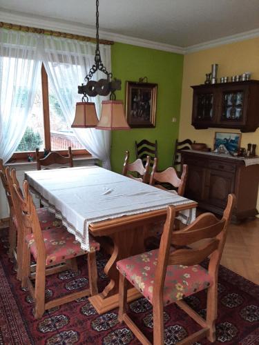 a dining room with a wooden table and chairs at Ferienwohnung Sankt Hubertus in Bad Berneck im Fichtelgebirge
