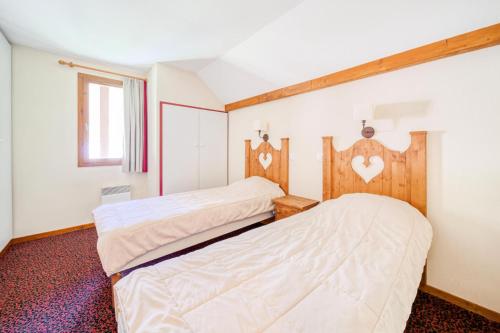 deux lits côte à côte dans une chambre dans l'établissement Résidence L'Alpaga - maeva Home - Appartement 3 pièces 8 Personnes - Budget MAE-2474, à La Salle Les Alpes
