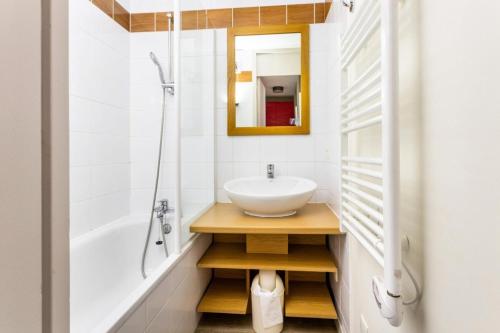 une salle de bain avec un lavabo, une baignoire et un miroir dans l'établissement Résidence Plagne Lauze - maeva Home - Studio 4 Personnes - Sélection MAE-3584, à Mâcot La Plagne