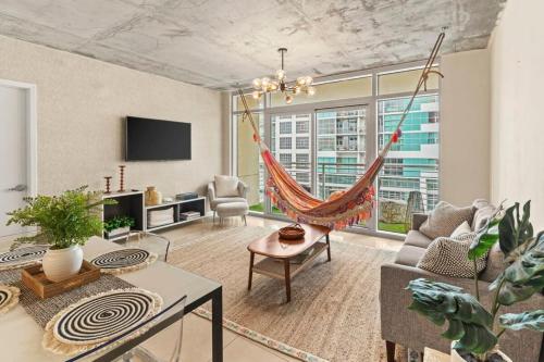 a living room with a hammock in the middle at Urban Retreat - Location Pool Gym & Parking in Miami
