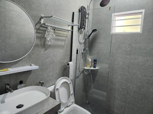 a bathroom with a shower and a toilet and a sink at Lovell 63 in Puchong