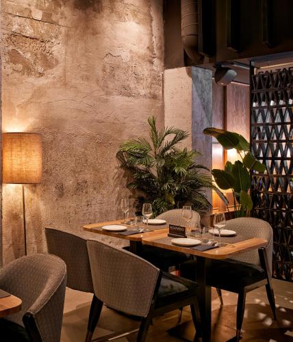 a dining room with a wooden table and chairs at Bilder Boutique Hotel in Bilbao