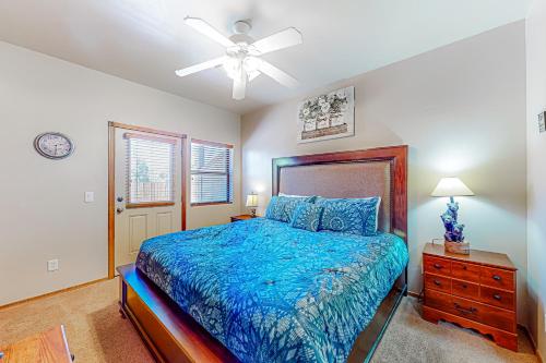 a bedroom with a bed and a ceiling fan at TreeTop Solitude in Show Low