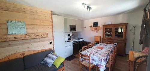 een keuken en eetkamer met een tafel en stoelen bij Les Chalets D'arrondaz - 4 Pièces pour 8 Personnes 03 in Modane