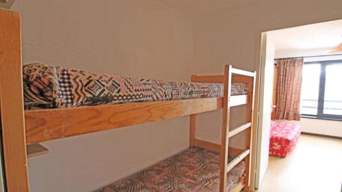 a bedroom with two bunk beds and a doorway at Résidence Podium - Studio pour 3 Personnes 974 in Les Prés
