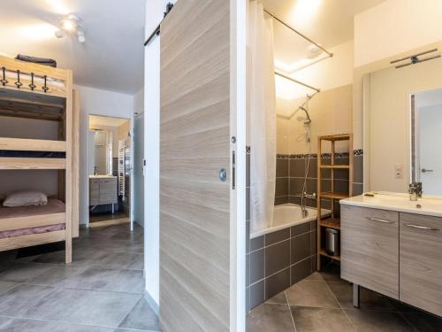 a bathroom with a shower and a sink and a tub at Résidence LODGES 1970 - Appartement LODGES A405 pour 6 Personnes 45 in La Plagne