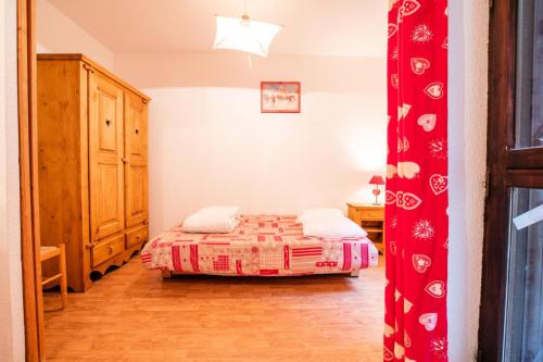 - une petite chambre avec un lit et une commode dans l'établissement Résidence Les Campanules - LES CAMPANULES - CA15FC MAE-3064, à Villarodin-Bourget