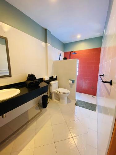 a bathroom with a toilet and a sink and a shower at Forget Me Not Boutique Bed & Breakfast Hua Hin in Hua Hin