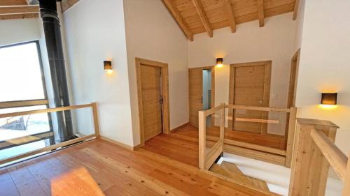 an empty room with wooden floors and wooden doors at Chalet - Chalets pour 12 Personnes 644 in Les Prés