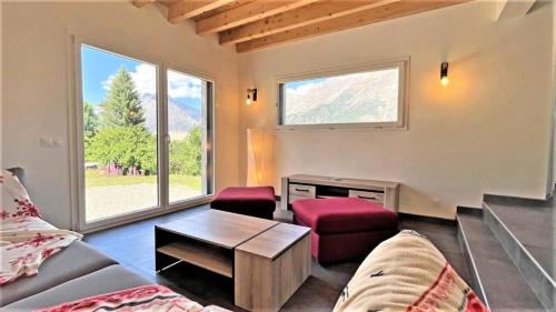a living room with a couch and a table at Chalet - Chalets pour 10 Personnes 774 in Les Prés
