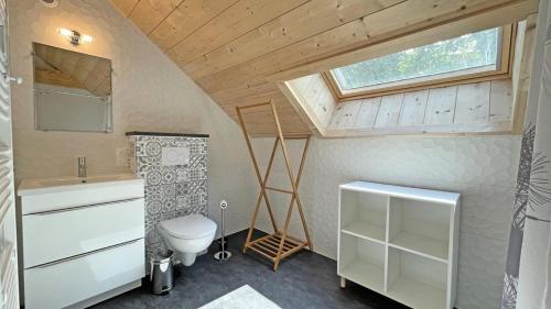 a small bathroom with a toilet and a sink at Chalet - Chalets pour 10 Personnes 774 in Les Prés