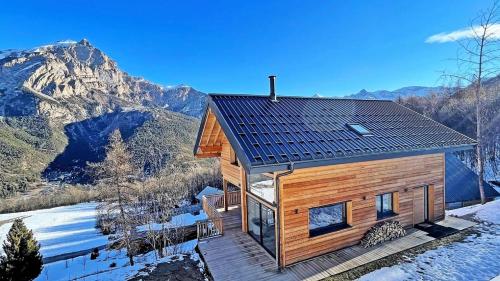 a log cabin in the snow with a mountain in the background at Chalet - Superbe Chalet 12 pers MAE-2644 in Les Prés