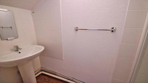 une salle de bain blanche avec un lavabo et un miroir dans l'établissement Résidence Dame Blanche - DBA304 - APPT 2 CHAMBRES + COIN MONTAGNE - BALCON - 8 PERSONNES MAE-3094, à Narreyroux
