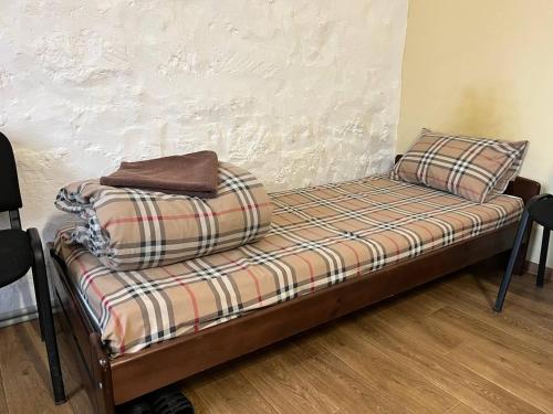 a bed with two pillows sitting on top of it at FOX Hostel in Mykolaiv