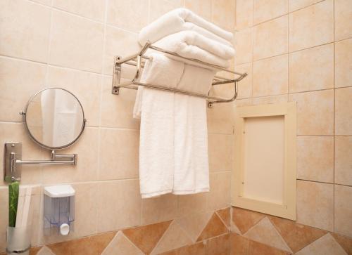 a bathroom with white towels hanging on a wall at Riyadh Al Deafah Hotel in Mecca