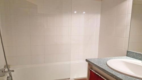 une salle de bain avec une baignoire blanche et un lavabo dans l'établissement Résidence Parc Aux Etoiles - B204PAE - APPARTEMENT DUPLEX 2 CHAMBRES, BALCON MAE-8714, à Narreyroux