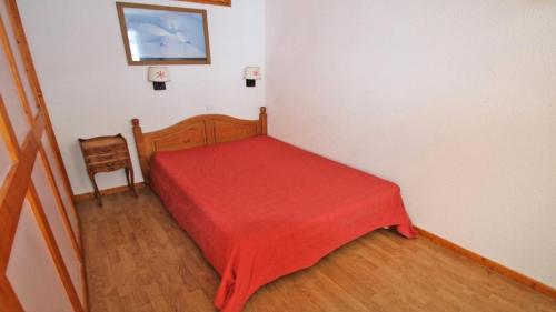 - une petite chambre avec une couverture rouge sur un lit dans l'établissement Résidence Parc Aux Etoiles - A109PAE - APPARTEMENT SPACIEUX AVEC BALCON MAE-8654, à Narreyroux